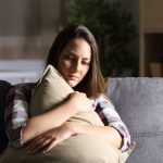 girl with anxiety holding pillow